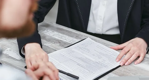 A cropped picture of a person filling out a form